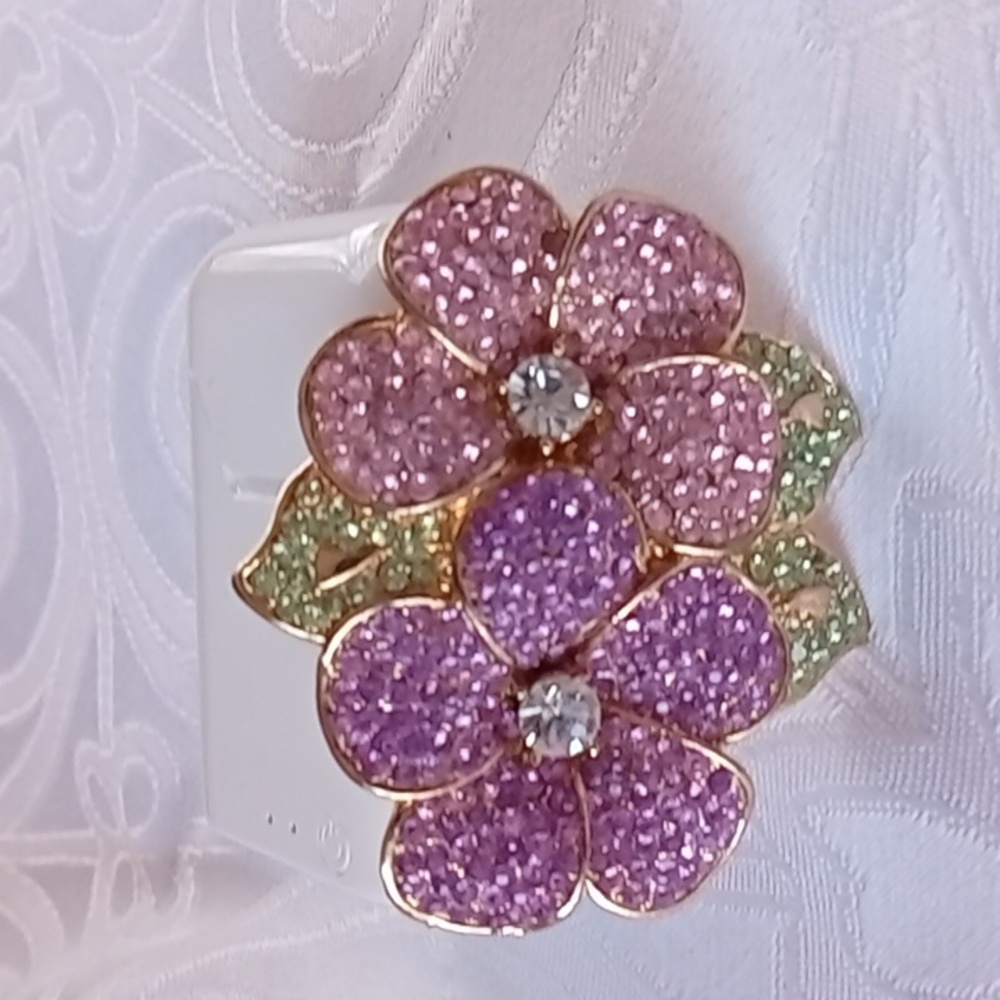 Pink and Lavender rhinestone brooch with green leaves set in goldtone